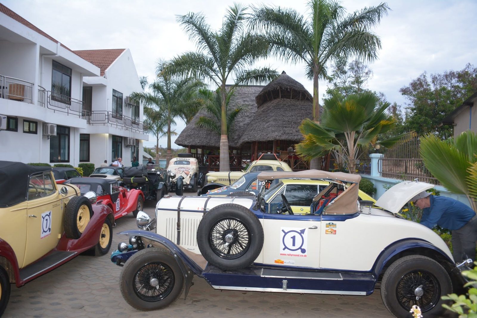 Vamos Hotel Mikumi guest parking with thatched restaurant